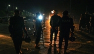 Policemen stand guard at the Red Zone area, early in Islamabad on November 27, 2024. (Photo by Aamir Qureshi / AFP)