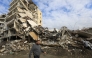 This picture taken a day after a ceasefire between Israel and Hezbollah shows a man walking past destroyed buildings in the southern Lebanese city of Nabatieh on November 28, 2024. Photo by AFP.