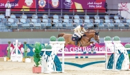 Oman’s Sgt. Madian Said Hamad Al Yusfi guides Hurry Up over a hurdle.