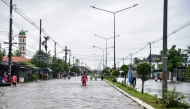 People through flood waters along a street following heavy rain in Thailand's southern province of Narathiwat on November 28, 2024. Photo by Madaree TOHLALA / AFP