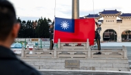 Guards raise Taiwan's national flag on the Democracy Boulevard at the Chiang Kai-shek Memorial Hall in Taipei on November 29, 2024. (Photo by I-Hwa Cheng / AFP)