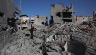 A Palestinian man stands amid the rubble of a building destroyed in an Israeli strike on the Shujaiyah neighbourhood in Gaza City in the northern Gaza Strip on November 30, 2024. (Photo by Omar AL-QATTAA / AFP)
