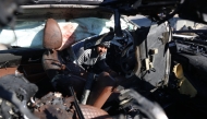 A man checks a car hit by an Israeli strike in Khan Yunis in the southern Gaza Strip on November 30, 2024, in which five people were targeted, including three World Central Kitchen (WCK) workers, according to a report by the civil defence in the Palestinian territory. Photo by BASHAR TALEB / AFP.