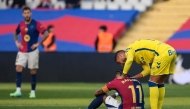 Barcelona's Brazilian forward #11 Raphinha (C) is consoled by Las Palmas' Spanish midfielder #11 Benito Ramirez (R) after their Spanish league football match between FC Barcelona and UD Las Palmas at the Estadi Olimpic Lluis Companys in Barcelona on November 30, 2024. (Photo by Josep LAGO / AFP)
