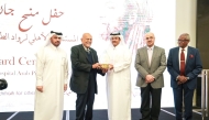 Chairman of the Board of the Medicare Group and Al-Ahli Hospital H E Sheikh Abdullah bin Thani Al Thani (centre) presenting an award to Sir Magdi Yacoub at the event.