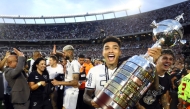 Botafogo's forward #99 Igor Jesus celebrates with the trophy after winning the Copa Libertadores final football match in Buenos Aires on November 30, 2024. (Photo by Alejandro Pagni / AFP)