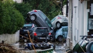 Cars piled on top of each other in the city of Rhodes after heavy rainfall, on the Greek island of Rhodes, on December 1, 2024. (Photo by Stringer / Eurokinissi / AFP) 
 