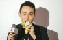 Chinese-born crypto founder Justin Sun eats banana artwork, in Hong Kong on November 29, 2024. (Photo by Peter Parks / AFP)
