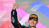 Race winner Red Bull Racing's Dutch driver Max Verstappen celebrates on the podium after the Qatari Formula One Grand Prix at the Lusail International Circuit in Lusail, north of Doha, on December 1, 2024. (Photo by Giuseppe CACACE / AFP)
