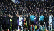 Fiorentina and Inter Milan players react as Fiorentina's Italian midfielder #04 Edoardo Bove receives medical attention after suddenly collapsing to the ground during the Serie A football match between Fiorentina and Inter Milan at the Artemio Franchi stadium in Florence on December 1, 2024. (Photo by TIZIANA FABI / AFP)
