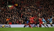 Liverpool's Egyptian striker #11 Mohamed Salah shoots from the penalty spot to score the team's second goal during the English Premier League football match between Liverpool and Manchester City at Anfield in Liverpool, north west England on December 1, 2024. (Photo by Adrian Dennis / AFP)