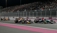 Mercedes' British driver George Russell, Red Bull Racing's Dutch driver Max Verstappen and McLaren's Australian driver Oscar Piastri compete during the Qatar Formula One Grand Prix at the Lusail International Circuit in Lusail, north of Doha, on December 1, 2024. (Photo by Andrej Isakovic / AFP)
 