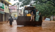 A family is being rescued from a cyclone-affected area after heavy rainfall in Puducherry on December 1, 2024. (Photo by AFP)
 