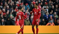 Liverpool's Egyptian striker #11 Mohamed Salah celebrates scoring the team's first goal with Liverpool's Dutch defender #04 Virgil van Dijk on October 20, 2024. (Photo by Paul Ellis / AFP)

