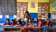 Children attend a class at a school in New Delhi on December 3, 2024. (Photo by Arun Sankar / AFP)