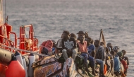 (FILES) A 'cayuco' boat from Senegal with 136 migrants onboard including 40 women and 17 young children arrives after being rescued at sea by a Spanish Salvamento Maritimo (Sea Search and Rescue agency) vessel, at La Restinga port on the Canary island of El Hierro, on November 28, 2024. (Photo by Antonio SEMPERE / AFP)
