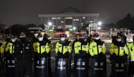 Police stand guard in front of the main gate of the National Assembly in Seoul on December 3, 2024, after South Korea's President Yoon Suk Yeol declared emergency martial law. Photo by Jung Yeon-je / AFP