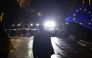 A protester waves a European Union flag in front of police during the fifth straight night of demonstrations against the government's postponement of EU accession talks until 2028, in central Tbilisi early on December 3, 2024. Photo by Giorgi ARJEVANIDZE / AFP.