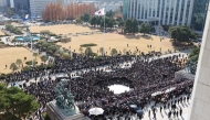 Opposition party members and members of civic groups hold a rally to ask for the resignation of South Korea President Yoon Seoul Yeol on the steps in front of the National Assembly building in Seoul on December 4, 2024. (Photo by Yonhap / AFP) 