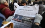 Photo used for representational purposes. A man reads an extra edition newspaper in downtown Seoul on December 4, 2024, after martial law was lifted. Photo by Jung Yeon-je / AFP.