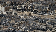 File: This photograph taken from the panoramic terrace of the Montparnasse tower, shows the zinc rooftops of Haussmannian buildings in Paris, on September 6, 2023. (Photo by Miguel Medina / AFP)