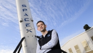 Inspiration4 mission commander Jared Isaacman, founder and chief executive officer of Shift4 Payments, stands for a portrait in front of the recovered first stage of a Falcon 9 rocket at Space Exploration Technologies Corp. (SpaceX) on February 2, 2021 in Hawthorne, California. (Photo by Patrick T. Fallon / AFP)