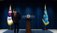 This handout photo taken and released on December 7, 2024 by the South Korean Presidential Office shows South Korea's President Yoon Suk Yeol bowing after the end of his address at the Presidential Office in Seoul. (Photo by Handout / South Korean Presidential Office / AFP) 