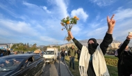 People celebrate at Umayyad Square in Damascus on December 8, 2024. (Photo by Louai Beshara / AFP)
 