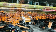 McLaren’s drivers Lando Norris and Oscar Piastri celebrate with their team members after winning constructor’s title.