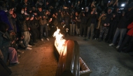 Photo used for representational purposes. Anti-government demonstrators take photographs of a coffin containing an image depicting Georgian billionaire Bidzina Ivanishvili as it burns after being set on fire during the twelfth consecutive day of mass protests against the government's postponement of EU accession talks until 2028, in central Tbilisi on December 9, 2024. Photo by Giorgi ARJEVANIDZE / AFP