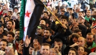 People cheer as they gather a the Karama square to welcome the arrival of rebel fighters from Aleppo and Daraa governorates in the southern Syrian city of Sweida on December 10, 2024.
Photo by SHADI AL DUBAISI / AFP.