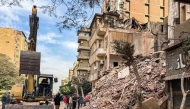 An excavator is stationed outside a collapsed building in the Waili district of central Cairo on December 10, 2024. Photo by AFP