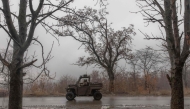 A Ukrainian soldier drives a vehicle on a road leading to the town of Chasiv Yar, in Kostyantynivka, eastern Donetsk region, on December 10, 2024. (Photo by Roman Pilipey / AFP)