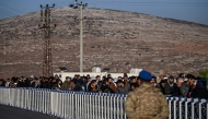 Syrian who lives in Turkey wait in a queue at Cilvegozu crossborder gate before entering in Syria at Reyhanli district in Hatay, on December 9, 2024. (Photo by Ozan Kose / AFP)

