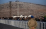 Syrian who lives in Turkey wait in a queue at Cilvegozu crossborder gate before entering in Syria at Reyhanli district in Hatay, on December 9, 2024. (Photo by Ozan Kose / AFP)

