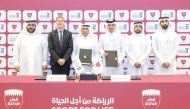 QOC Secretary General Jassim bin Rashid Al Buenain and President of University of Doha for Science and Technology Dr. Salem bin Nasser Al Naemi pose for a group picture along with other officials.  