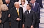 French President Emmanuel Macron (R) and US President-elect Donald Trump (C) speak ahead of a ceremony to mark the re-opening of the landmark Notre-Dame Cathedral, in central Paris, on December 7, 2024. (Photo by Ludovic Marin / Pool / AFP)