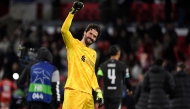 Liverpool's Brazilian goalkeeper #01 Alisson Becker celebrates at the end of the UEFA Champions League, league phase football match between Girona FC and Liverpool FC at the Montilivi stadium in Girona on December 10, 2024. (Photo by Josep LAGO / AFP)