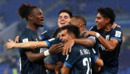 Pachuca's Moroccan midfielder #11 Oussama Idrissi celebrates with teammates after scoring his team's first goal during the 2024 FIFA Intercontinental Cup football match between Brazil's Botafogo and Mexico's Pachuca at Stadium 974 in Doha on December 11, 2024. (Photo by Karim Jaafar / AFP)