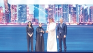 Minister of Communications and Information Technology H E Mohammed bin Ali bin Mohammed Al Mannai presenting the award to the Executive Vice President Infrastructure Services of QNB Group, Fatma Al Baker, during the Microsoft AI Tour.