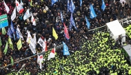 Police (bottom) attempt to block protesters calling for the impeachment of South Korea President Yoon Suk Yeol and the dissolution of the People's Power Party from marching towards the presidential office in Seoul on December 12, 2024. Photo by YONHAP / AFP