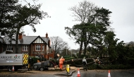 Arborists cut a tree blocking a road in Birkenhead, near Liverpool, on December 7, 2024 as storm Darragh brings winds of nearly 90 mph to the west of Wales and north-west England. (Photo by Paul Ellis / AFP)
