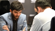 India's grandmaster Gukesh Dommaraju (L) competes against China's chess grandmaster Ding Liren in game 14 of the 2024 FIDE World Championship in Singapore on December 12, 2024. (Photo by Simon Lim / AFP)
