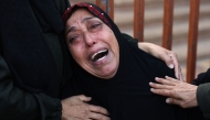 A Palestinian woman cries outside Nasser Hospital in Khan Yunis in the south Gaza Strip, on December 12, 2024. (Photo by Bashar Taleb / AFP)