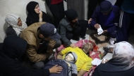 Palestinians mourn relatives, killed in an Israeli airstrike, ahead of their funeral in the Nuseirat refugee in the central Gaza Strip on December 13, 2024. Photo by Eyad BABA / AFP.