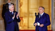 France's outgoing Prime minister Michel Barnier (left) applauds newly-appointed Prime Minister and President of the Democratic Movement (MoDem) party Francois Bayrou (right) during a handover ceremony at the Hotel Matignon in Paris on December 13, 2024. (Photo by Abdul Saboor / POOL / AFP)