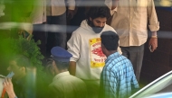 Indian actor Allu Arjun (centre) comes out of the Chikkadpally police station following his arrest by the police in Hyderabad on December 13, 2024. (Photo by Noah Seelam / AFP)
