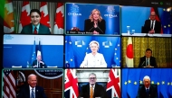 This handout picture taken in Rome and released on December 13, 2024 by Italy's Prime Minister press office (Palazzo Chigi Press Office), shows a screen displaying the G7 leaders meeting by video link. From top left : Canada's Prime Minister Justin Trudeau, Italy's Prime Minister Giorgia Meloni, Germany's Chancellor Olaf Scholz, France's France's Foreign Affairs Minister Jean-Noel Barrot, President of the European Commission Ursula von der Leyen, Japan's Prime Minister Shigeru Ishiba, US President Joe Biden, Britain's Prime Minister Keir Starmer and President of the European Council Antonio Costa. (Photo by Handout / Palazzo Chigi press office / AFP) 