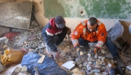 Rescuers look for survivors following an Israeli strike on the UNWRA Al-Majda Wasila Governmental School housing displaced Palestinians, on al-Jalaa Street in Gaza City on December 14, 2024. (Photo by Omar AL-QATTAA / AFP)
