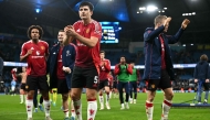 Manchester United's English defender #05 Harry Maguire applauds the fans following the English Premier League football match, on December 15, 2024. (Photo by Paul Ellis / AFP) 